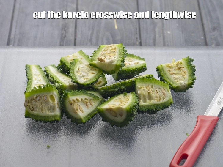 Step 5 – <p>Cut the <a href="https://www.tarladalal.com/glossary-bitter-gourd-karela-214i#ing_2439"><u>bitter gourd (karela)</u></a> crosswise and lengthwise. You will now have four pieces …
