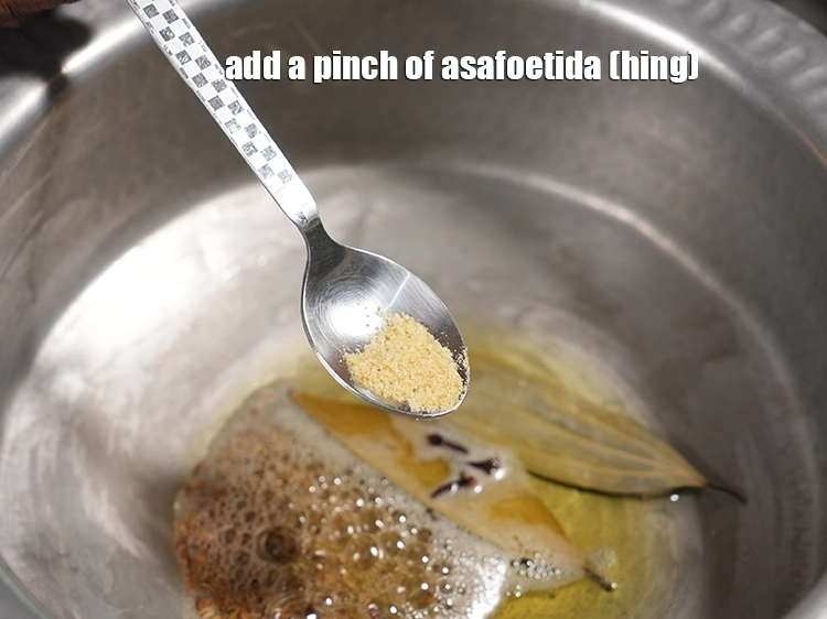 Step 23 – <html><head></head><body><p>Add&nbsp;<span style="background-color:rgb(255,255,255);color:rgb(0,0,0);">a pinch of </span><a href="https://www.tarladalal.com/glossary-asafoetida-hing-113i"><u>asafoetida (hing)</u></a><u>.</u></p></body></html>