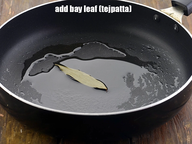 Step 10 – <p>Add the spices to it. First we will add the <span style="background-color:rgb(255,255,255);color:rgb(0,0,0);">1 </span><a href="https://www.tarladalal.com/glossary-bay-leaf-tejpatta-bay-leaves-189i"><u>bay leaf …