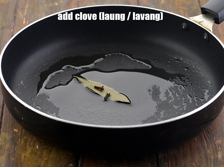 Step 11 – <p>Now add the <span style="background-color:rgb(255,255,255);color:rgb(0,0,0);">2 </span><a href="https://www.tarladalal.com/glossary-cloves-laung-lavang-322i"><u>clove (laung / lavang)</u></a>.</p>