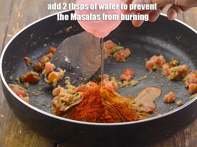 Step 26 – <p>Also, add 2 tbsps. of <strong>water</strong> to prevent the Masalas from burning.</p>