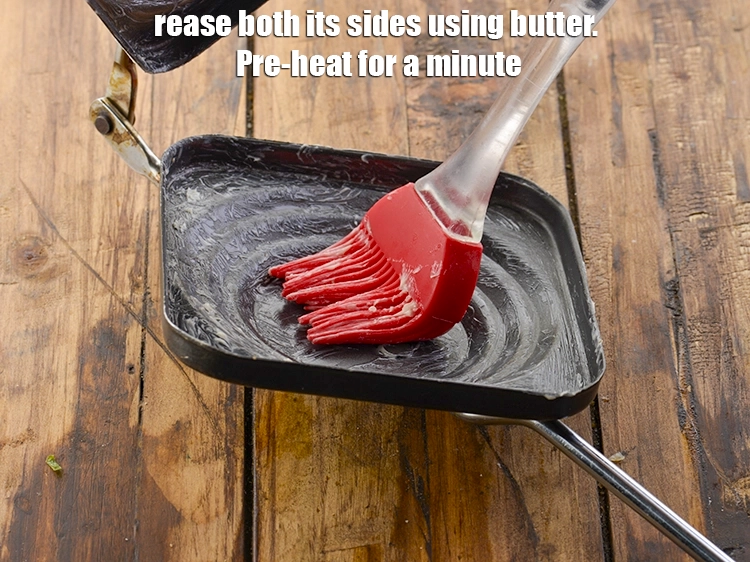 Step 13 – <p>Take a <strong>sandwich toaster</strong> and grease both its sides using <a href="https://www.tarladalal.com/glossary-butter-makhan-233i"><u>butter</u></a>. Pre-heat for a …