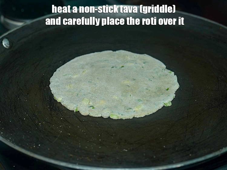 Step 11 – <p>To cook the <strong>hara lehsun roti</strong>, heat a non-stick tava (griddle) and carefully place the …