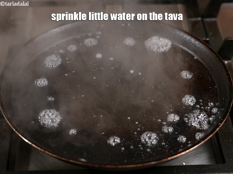 Step 15 – <p><span style="color:rgb(0,0,0);">Sprinkle little <strong>water</strong> on the tava, it should sizzle immediately.&nbsp; If the water is …