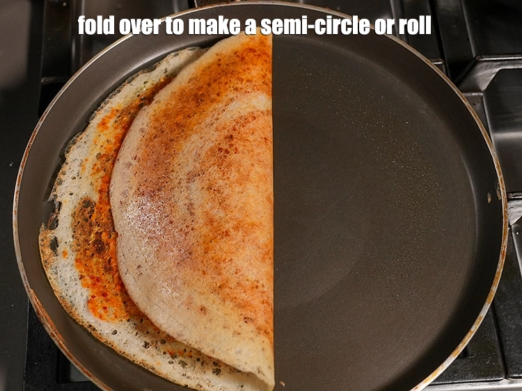 Step 23 – <p>Fold&nbsp;<strong>Mysore sada dosa</strong>&nbsp;over to make a semi-circle or a roll.</p>