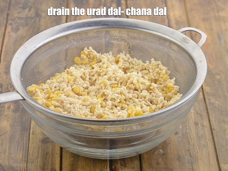Step 12 – <p>Drain the <strong>urad dal-chana dal</strong> mixture using a strainer.</p>