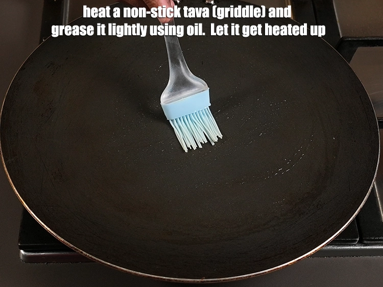 Step 19 – <p>Heat a non-stick tava (griddle) and grease it lightly using <strong>oil</strong>. Let it get heated …