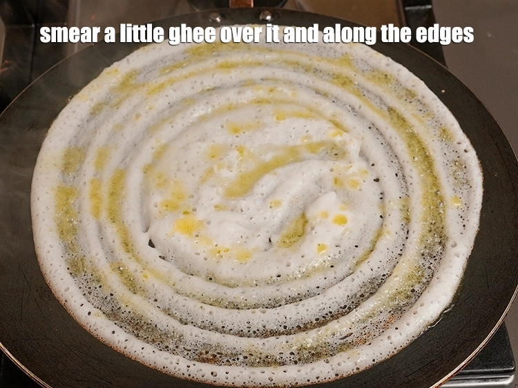Step 24 – <p><span style="background-color:rgb(255,255,255);color:rgb(0,0,0);">Smear a little </span><a href="https://www.tarladalal.com/glossary-ghee-245i"><u>ghee</u></a><span style="background-color:rgb(255,255,255);color:rgb(0,0,0);"> over it and along the edges.</span></p>