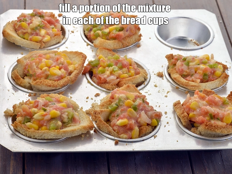 Step 12 – <p><span style="background-color:rgb(255,255,255);color:rgb(0,0,0);">Fill a portion of the <strong>mixture</strong> in each of the <strong>bread cups.</strong></span></p>
