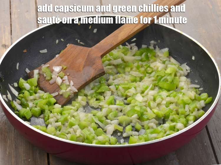 Step 8 – <p><span style="background-color:rgb(255,255,255);color:rgb(0,0,0);">Add the 1/2 cup </span><a href="https://www.tarladalal.com/glossary-capsicum-shimla-mirch-bell-pepper-163i#ing_2311"><u>chopped capsicum</u></a><span style="background-color:rgb(255,255,255);color:rgb(0,0,0);"> and 2 tsp finely </span><a href="https://www.tarladalal.com/glossary-green-chillies-hari-mirch-331i#ing_2388"><u>chopped …