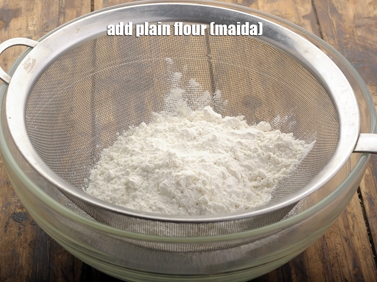 Step 8 – <p>Add <span style="background-color:rgb(255,255,255);color:rgb(0,0,0);">1 cup </span><a href="https://www.tarladalal.com/glossary-plain-flour-maida-188i"><u>plain flour (maida)</u></a><u>.</u></p>