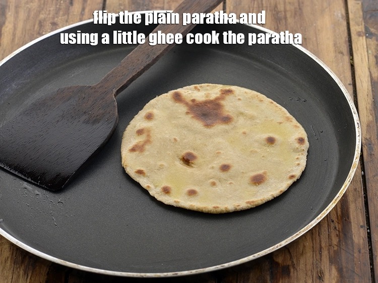 Step 41 – <p>Flip the&nbsp;<strong>plain paratha</strong>&nbsp;and using a little ghee cook the paratha.</p>