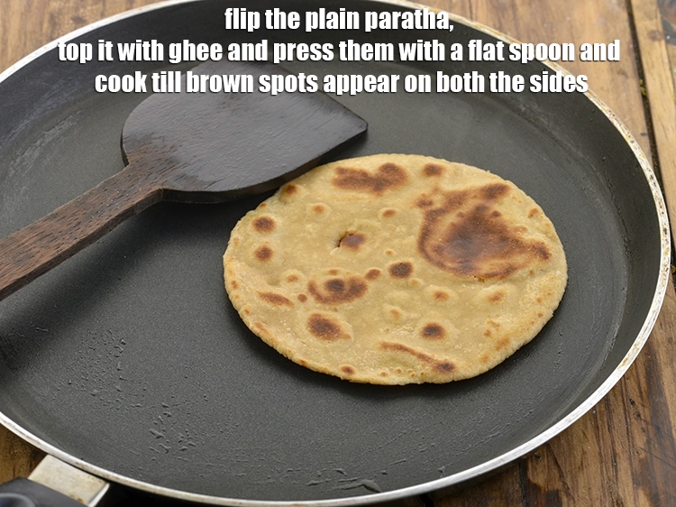 Step 42 – <p>Flip the&nbsp;<strong>plain paratha</strong>, top it with ghee and press them with a flat spoon and …
