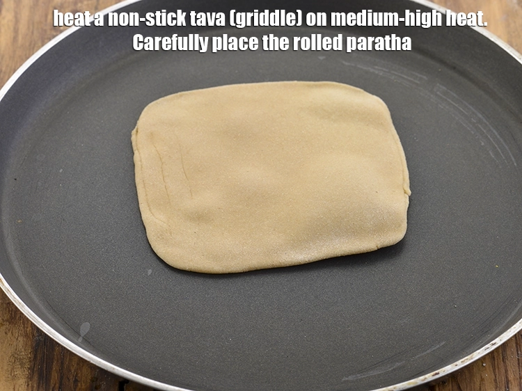 Step 35 – <p>For frying the <strong>square plain paratha</strong>, heat a non-stick tava (griddle) on medium-high heat. Carefully …