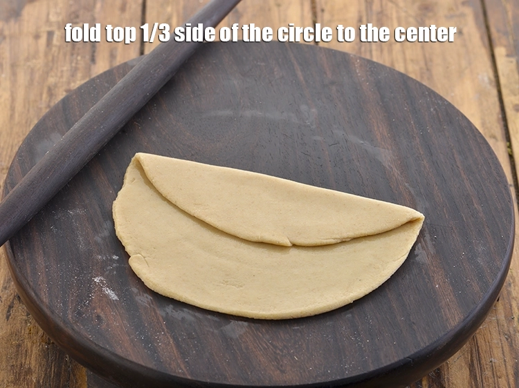 Step 27 – <p>Fold top 1/3 side of the circle to the center.</p>