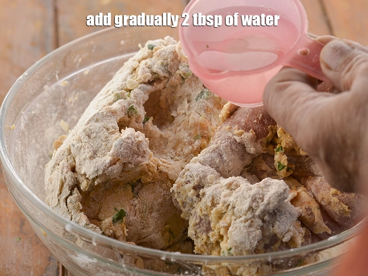 Step 17 – <p>Gradually 2 tbsp. of <strong>water</strong>, which would help in binding the&nbsp;<strong>Punjabi Mooli Paratha</strong>&nbsp;dough.</p>