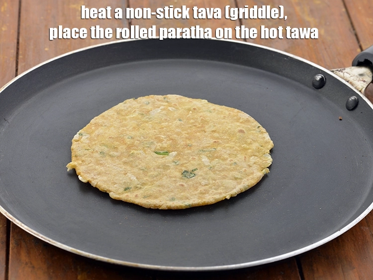 Step 22 – <p>Heat a non-stick tava (griddle) and place the rolled mooli<strong> paratha</strong> on the hot tawa.</p>