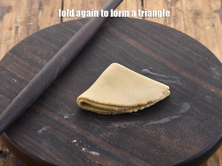 Step 17 – <p>Fold again to form a triangle.</p>