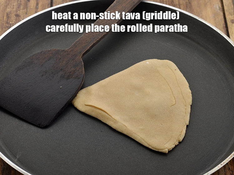 Step 19 – <p>For frying the <strong>triangular atta ka paratha</strong>, heat a non-stick tava (griddle) on medium-high heat. …