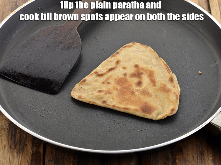 Step 22 – <p>Flip the&nbsp;<strong>plain paratha</strong>&nbsp;and cook till brown spots appear on both the sides. Alternatively, you can …