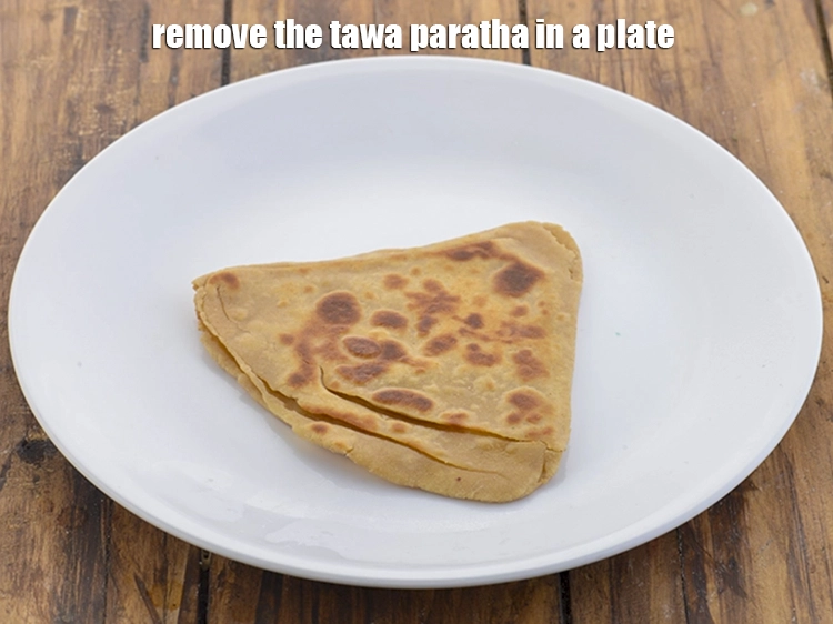 Step 45 – <p>Remove the <strong>tawa paratha</strong> in a plate.</p>