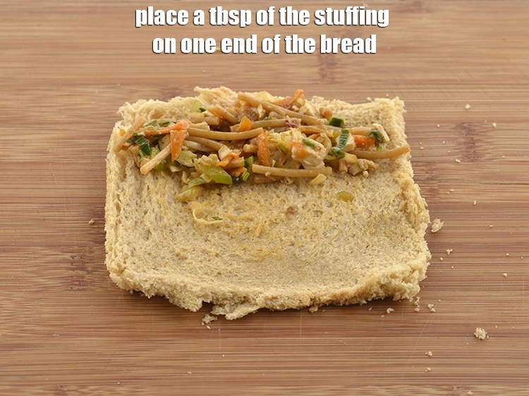 Step 26 – <p><span style="background-color:rgb(255,255,255);color:rgb(0,0,0);">Place a 1 tbsp. of the <strong>stuffing</strong> on one end of the bread.</span></p>