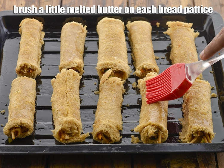 Step 32 – <p><span style="background-color:rgb(255,255,255);color:rgb(0,0,0);">Brush a little </span><a href="https://www.tarladalal.com/glossary-butter-makhan-233i#ing_3123"><u>melted butter</u></a><span style="background-color:rgb(255,255,255);color:rgb(0,0,0);"> on each b<strong>read pattice</strong>.</span></p>
