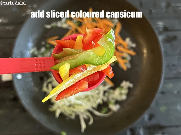 Step 13 – <html><head></head><body><p>Add&nbsp;3 tbsp&nbsp;sliced coloured&nbsp;<a href="https://www.tarladalal.com/glossary-capsicum-shimla-mirch-bell-pepper-163i#ing_2311"><u>capsicum</u></a>.</p></body></html>