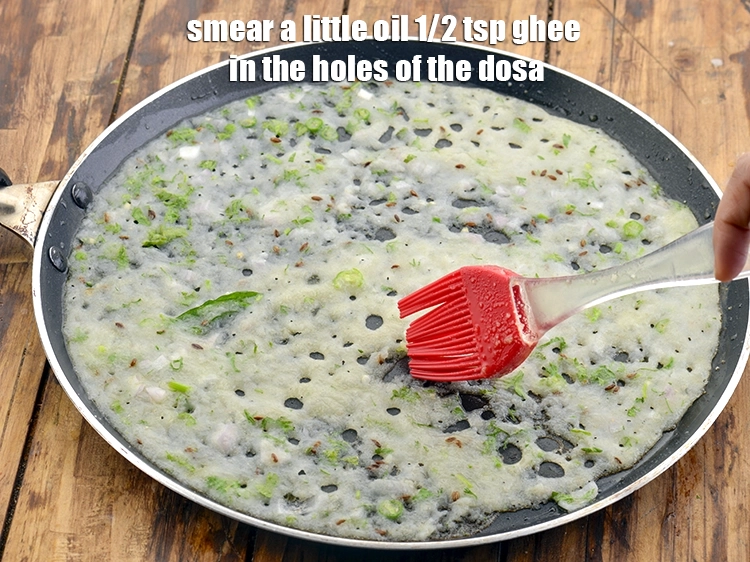 Step 29 – <p>Allow the <strong>dosa</strong> to cook on a medium flame, while smearing it with <a href="https://www.tarladalal.com/glossary-oil-671i"><u>oil</u></a>.&nbsp;</p>