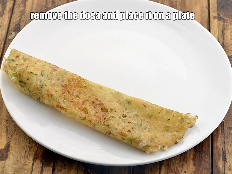 Step 24 – <p>Remove the&nbsp;<strong>instant rava dosa</strong>&nbsp;from the tava and place it on a plate.</p>