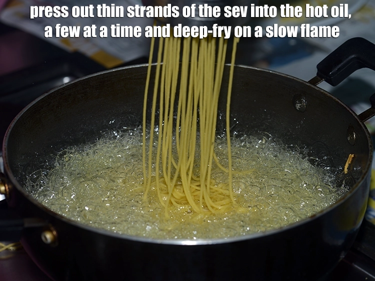 Step 4 – <p><span style="background-color:rgb(255,255,255);color:rgb(0,0,0);">Press out thin strands of the <strong>sev</strong> into the hot </span><a href="https://www.tarladalal.com/glossary-oil-671i"><u>oil</u></a><span style="background-color:rgb(255,255,255);color:rgb(0,0,0);">, a …