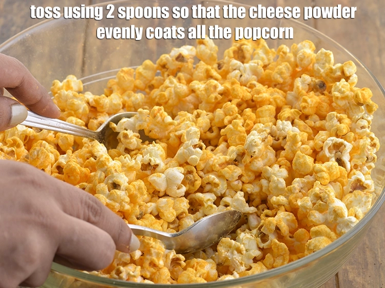Step 9 – <p>Toss using 2 spoons so that the cheese powder evenly coats all the popcorn. It …