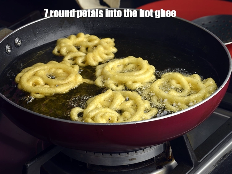 Step 11 – <p><span style="background-color:rgb(255,255,255);color:rgb(0,0,0);">7 round petals into the hot </span><a href="https://www.tarladalal.com/glossary-ghee-245i"><u>ghee</u></a><span style="background-color:rgb(255,255,255);color:rgb(0,0,0);"> and cook on a slow …