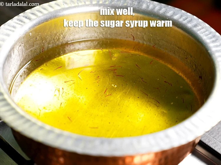 Step 9 – <p><span style="background-color:rgb(255,255,255);color:rgb(0,0,0);">Mix well. Keep the <strong>sugar syrup</strong> warm.</span></p>