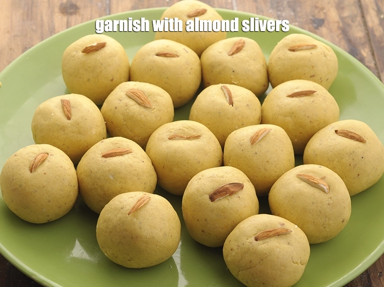 Step 17 – <p>Garnish the <strong>besan laddoos</strong> with almond <a href="https://www.tarladalal.com/glossary-almond-slivers-slivered-almonds-664i"><u>almond (badam) slivers</u></a>.</p>