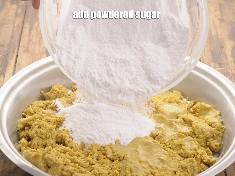 Step 10 – <p>Add <span style="background-color:rgb(255,255,255);color:rgb(0,0,0);">2 cups </span><a href="https://www.tarladalal.com/glossary-powdered-sugar-280i"><u>powdered sugar</u></a>. Do not add sugar into the hot mixture …