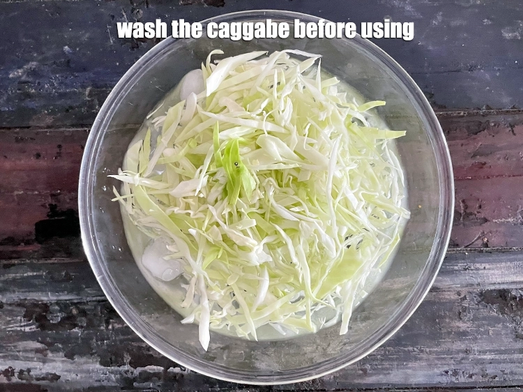 Step 20 – <p><strong>Wash</strong> the <a href="https://www.tarladalal.com/glossary-cabbage-patta-gobi-kobi-248i#ing_2354"><u>shredded cabbage</u></a> before using.</p>
