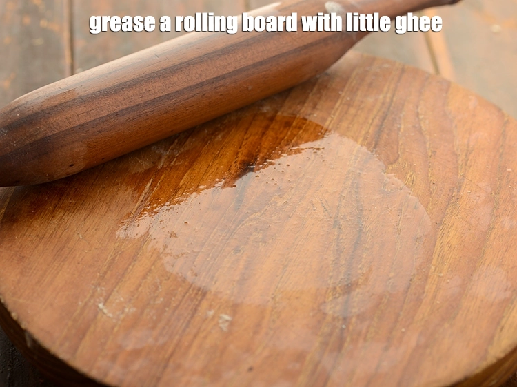 Step 13 – <p><span style="background-color:rgb(255,255,255);color:rgb(0,0,0);">Grease a rolling board with little ghee.</span></p>