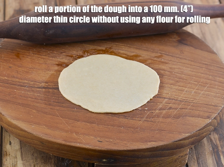 Step 14 – <p><span style="background-color:rgb(255,255,255);color:rgb(0,0,0);"><strong>Roll</strong> a portion of the dough into a 100 mm. (4”) diameter thin circle …