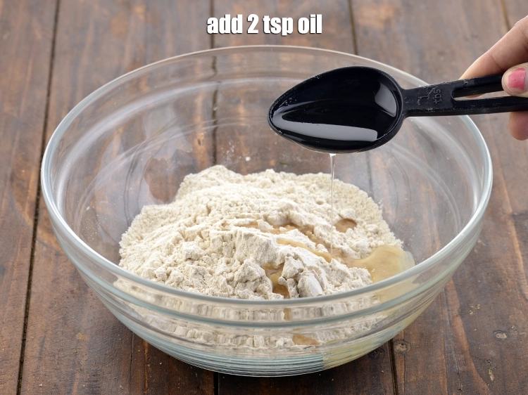 Step 2 – <p>Add the <span style="background-color:rgb(255,255,255);color:rgb(0,0,0);">2 tsp hot </span><a href="https://www.tarladalal.com/glossary-oil-671i"><u>oil</u></a><u>.</u></p>