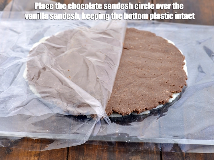Step 5 – <p><span style="background-color:rgb(255,255,255);color:rgb(0,0,0);">Place the <strong>chocolate sandesh</strong> circle over the vanilla sandesh, keeping the bottom plastic intact.</span></p>