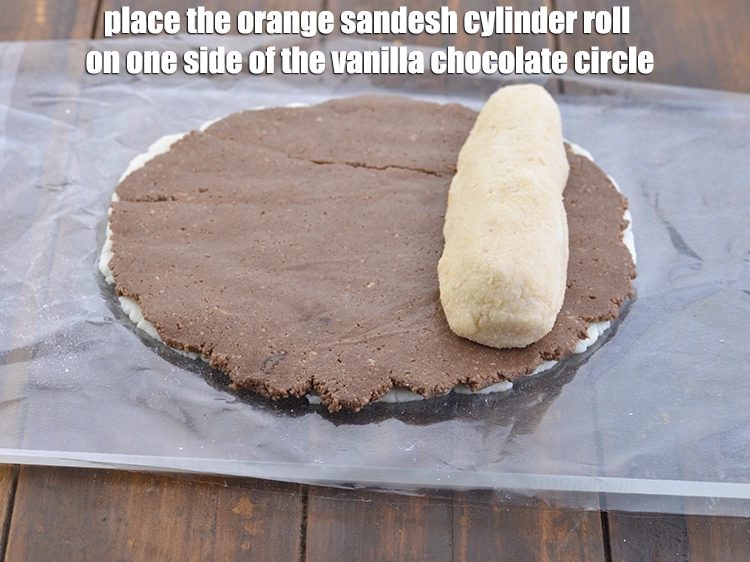 Step 6 – <p><span style="background-color:rgb(255,255,255);color:rgb(0,0,0);"><strong>Roll</strong> the <strong>orange sandesh</strong> into a 175mm (7”) long cylinder. Place the <strong>orange sandesh</strong> …