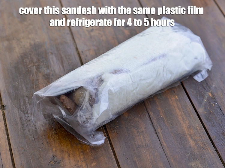 Step 8 – <p><span style="background-color:rgb(255,255,255);color:rgb(0,0,0);"><strong>Cover</strong> this <strong>sandesh</strong> with the same plastic film and <strong>refrigerate</strong> for 4 to 5 …