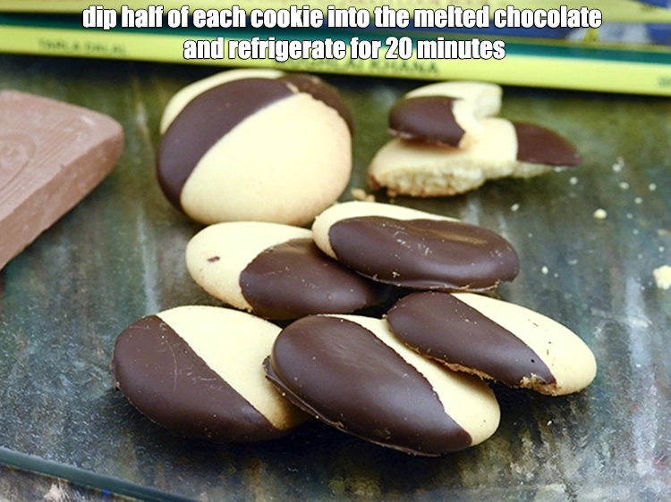 Step 23 – <p><span style="background-color:rgb(255,255,255);color:rgb(0,0,0);"><strong>Dip half </strong>of each <strong>cookie</strong> into the <strong>melted chocolate</strong> and allow to set on …