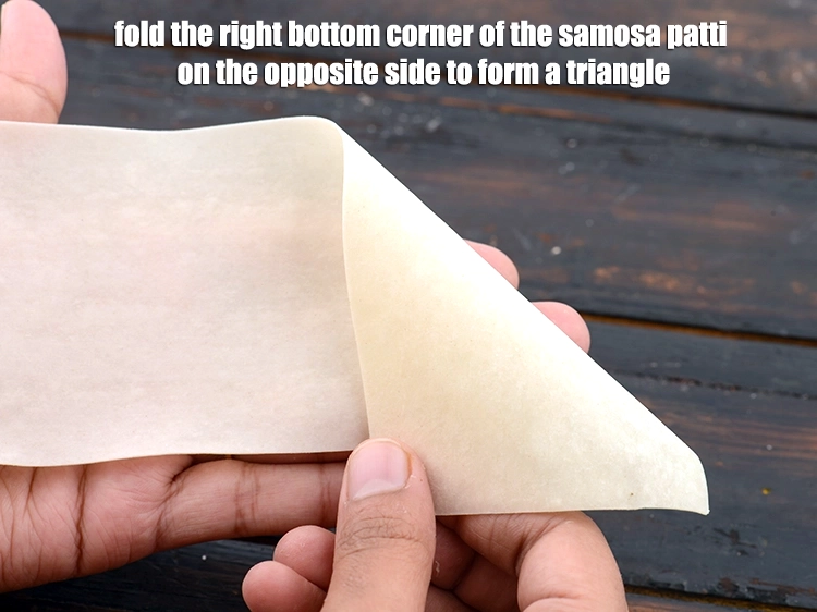 Step 10 – <p><span style="background-color:rgb(255,255,255);color:rgb(0,0,0);">Place a <strong>samosa patti</strong> on a clean, dry surface and fold the right bottom …