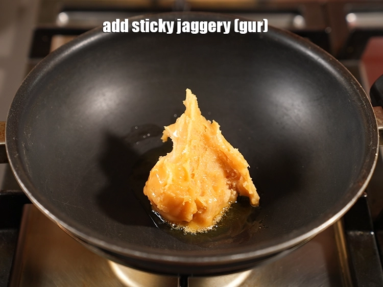 Step 9 – <p><span style="background-color:rgb(255,255,255);color:rgb(0,0,0);">Add the sticky 1/2 cup roughly </span><a href="https://www.tarladalal.com/glossary-jaggery-gur-gud-kala-gud-477i#ing_2805"><u>chopped jaggery (gur)</u></a><u>.</u></p>
