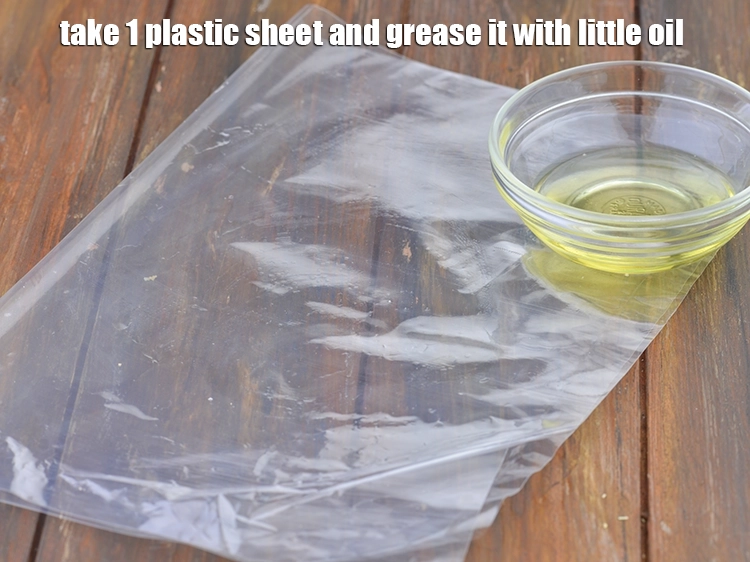 Step 3 – <p><span style="background-color:rgb(255,255,255);color:rgb(0,0,0);">Take 1 plastic sheet and grease it with little </span><a href="https://www.tarladalal.com/glossary-oil-671i"><u>oil</u></a><span style="background-color:rgb(255,255,255);color:rgb(0,0,0);">.</span></p>