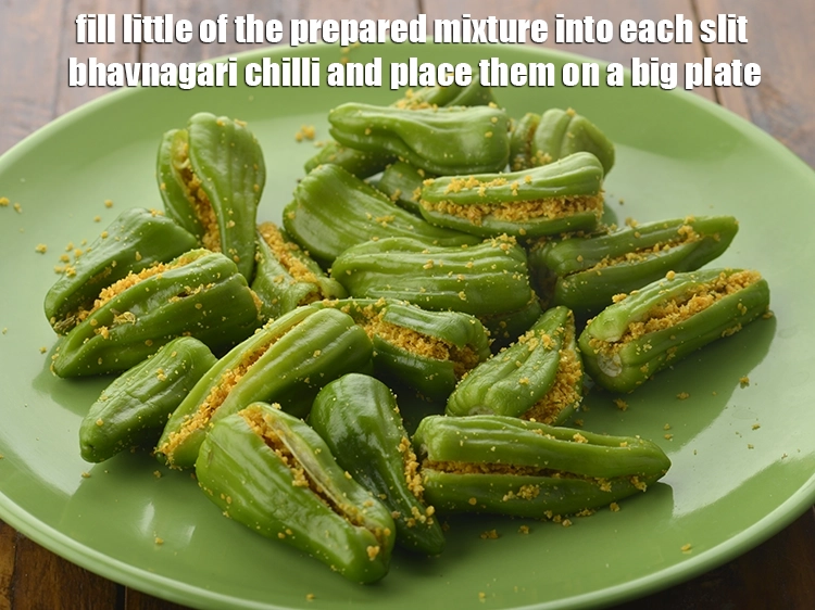 Step 6 – <p><span style="background-color:rgb(255,255,255);color:rgb(0,0,0);">Fill little of the <strong>prepared mixture</strong> into each <strong>slit bhavnagari chilli</strong> and place them …