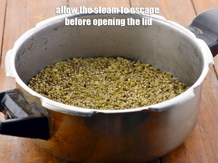 Step 26 – <p>Allow the steam to escape before opening the lid. Open the pressure cooker.</p>