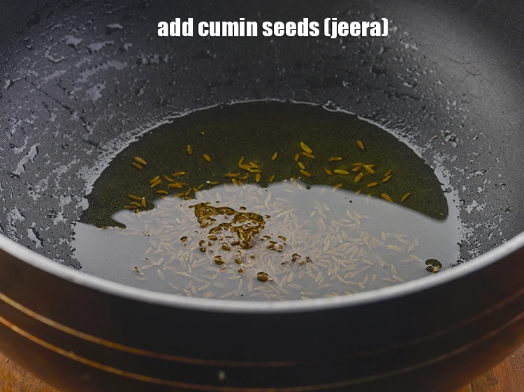 Step 15 – <p><strong>Once the ghee is hot</strong>, add the <span style="background-color:rgb(255,255,255);color:rgb(0,0,0);">1 tsp </span><a href="https://www.tarladalal.com/glossary-cumin-seeds-jeera-zeera-381i"><u>cumin seeds (jeera)</u></a>.</p>